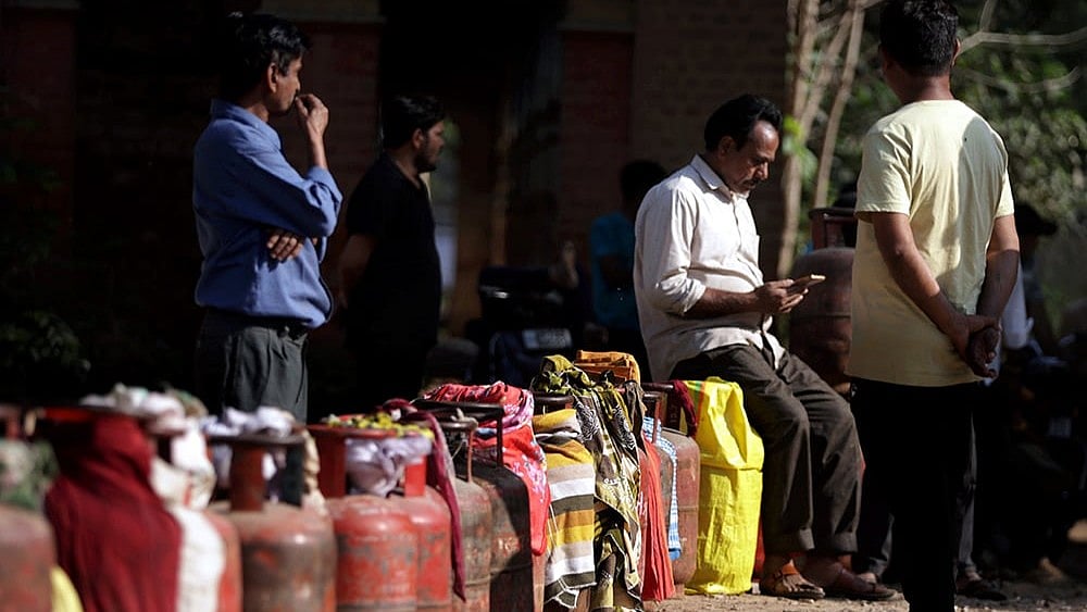 | Photo: PTI : People wait in a queue with empty LPG cooking gas cylinders to avail refilled ones amid the ongoing supply crisis, in Prayagraj.