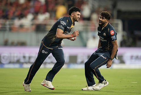Gujarat Titans' Ashok Sharma, left, celebrates with Mohammed Siraj after takes the catch to dismiss Punjab Kings' Priyansh Arya during the Indian Premier League cricket match between Gujarat Titans and Punjab Kings in New Chandigarh.