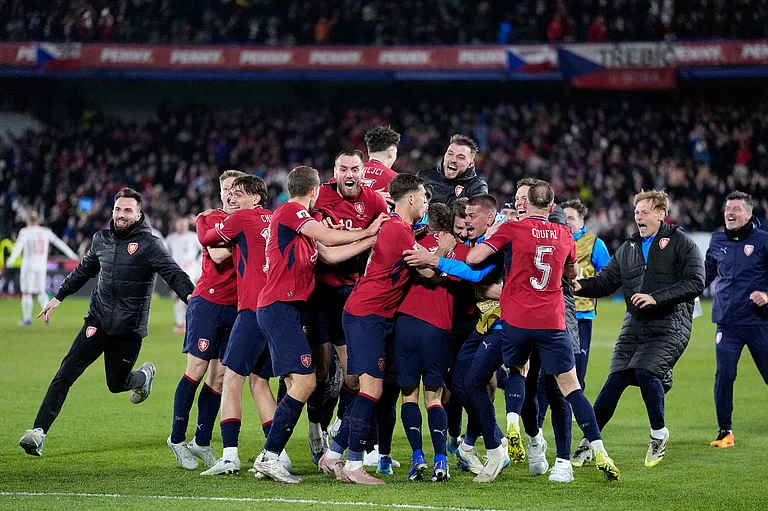 Czechia players celebrate after winning a penalty shootout at the end of the World Cup qualifying playoff final soccer match between Czechia and Denmark in Prague, Tuesday, March 31, 2026. - AP Photo/Petr David Josek