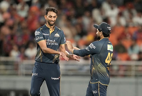 Gujarat Titans' Prasidh Krishna celebrates with teammates the wicket of Punjab Kings' captain Shreyas Iyer during the Indian Premier League cricket match between Gujarat Titans and Punjab Kings in New Chandigarh.
