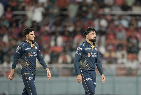 Gujarat Titans' Rashid Khan, front, celebrates the wicket of Punjab Kings' Prabhsimran Singh during the Indian Premier League cricket match between Gujarat Titans and Punjab Kings in New Chandigarh.