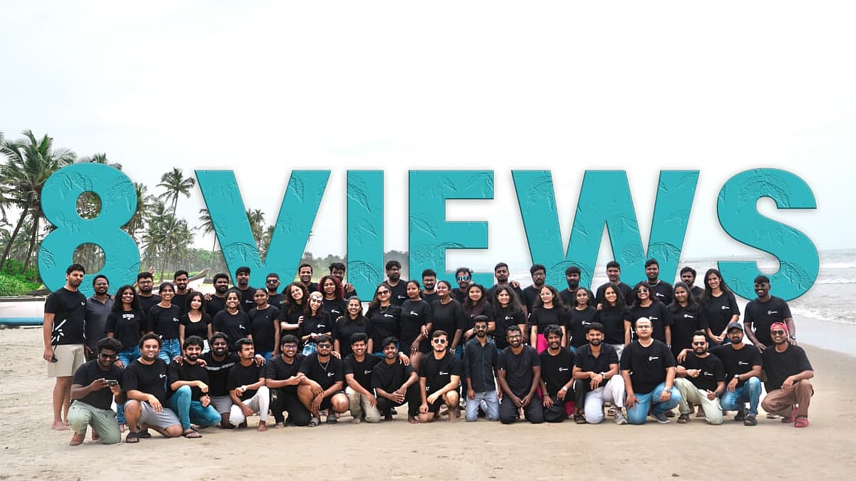 Large group on a beach behind "8 VIEWS" text