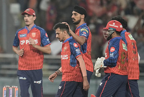 Punjab Kings' Yuzvendra Chahal, second from left, celebrates with teammates the wicket of Gujarat Titans' captain Shubman Gill during the Indian Premier League cricket match between Gujarat Titans and Punjab Kings in New Chandigarh.