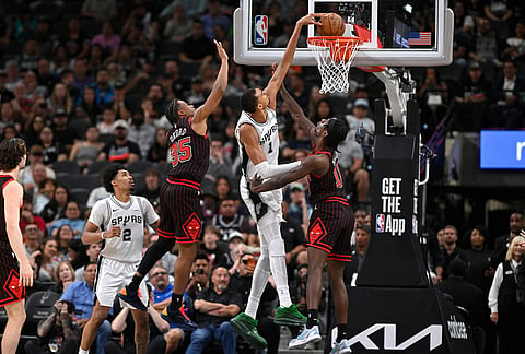 San Antonio Spurs center Victor Wembanyama (1) dunks against Chicago Bulls players Leonard Miller (11) and Isaac Okoro (35) during the second half of an NBA basketball game, in San Antonio.