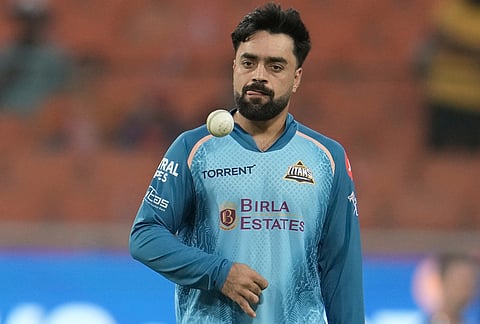 Gujarat Titans' Rashid Khan during a warm-up session before the start of the Indian Premier League cricket match between Gujarat Titans and Punjab Kings in New Chandigarh.