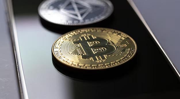 Bitcoin and Ethereum coins on a smartphone - null