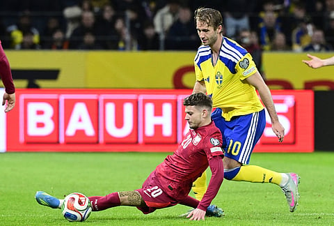 Poland's Sebastian Szymanski and Sweden's Benjamin Nygren during a World Cup qualifying playoff final soccer match between Sweden and Poland in Stockholm.