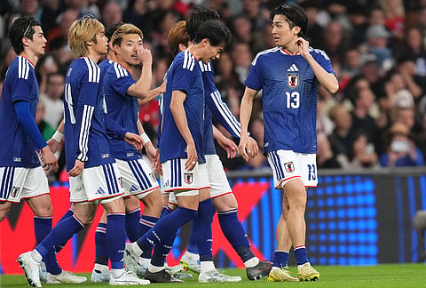 Japan players celebrate scoring their side's first goal during the International friendly soccer match between England and Japan in London.