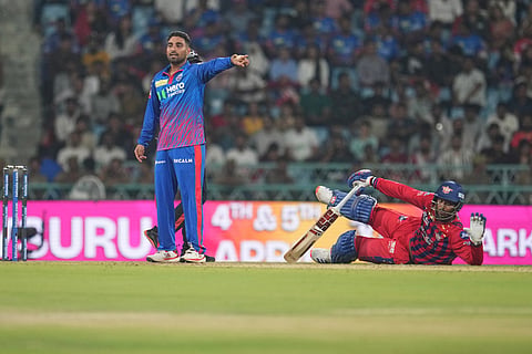 Delhi Capitals' Vipraj Nigam, left, gestures as Lucknow Super Giants' Mukul Choudhary falls on the ground during the Indian Premier League cricket match between Lucknow Super Giants and Delhi Capitals in Lucknow, India.