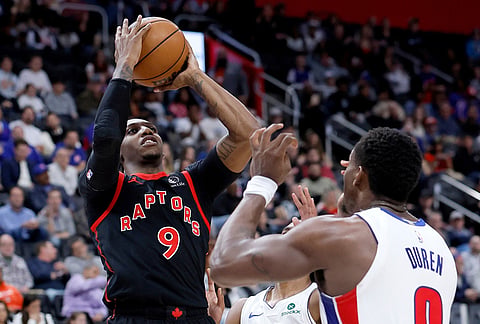 Toronto Raptors forward RJ Barrett (9) takes a shot against Detroit Pistons guard Daniss Jenkins, back, and center Jalen Duren (0) during the first half of an NBA basketball game in Detroit.