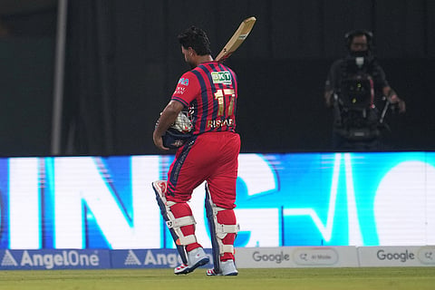 Lucknow Super Giants' captain Rishabh Pant walks off the field after losing his wicket during the Indian Premier League cricket match between Lucknow Super Giants and Delhi Capitals in Lucknow, India.