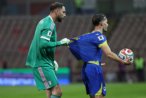 Italy goalkeeper Gianluigi Donnarumma pulls on the sort of Bosnia's Amar Dedic during the World Cup qualifying playoff final soccer match between Bosnia and Italy in Zenica, Bosnia.