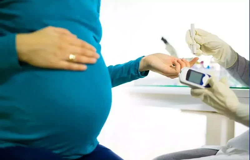 A pregnant woman getting blood glucose test