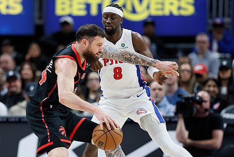 Toronto Raptors forward Sandro Mamukelashvili, left, drives against Detroit Pistons guard Caris LeVert (8) during the second half of an NBA basketball game in Detroit. 
