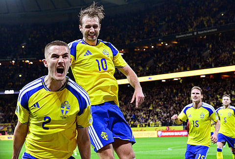 Sweden's Gustaf Lagerbielke, left, celebrates after scoring their second goal during a World Cup qualifying playoff final soccer match between Sweden and Poland in Stockholm.
