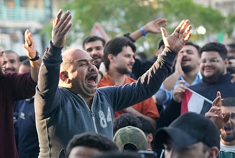 Iraqi soccer fans cheer to Iraqi team playing against Bolivia in a World Cup 2026 playoff final, at a cafe in central Baghdad, Iraq.