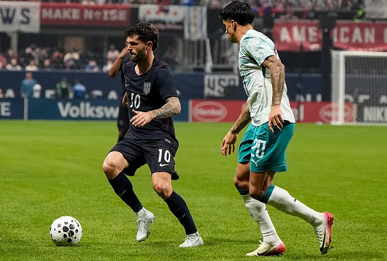 USA's Christian Pulisic (10) moves against Portugal's Joao Cancelo during the first half of an international friendly soccer match in Atlanta. - | Photo: AP/Mike Stewart