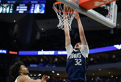 Dallas Mavericks forward Cooper Flagg (32) dunk against Milwaukee Bucks during the second half of an NBA basketball game in Milwaukee. 