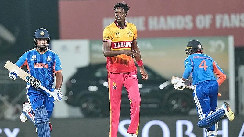 Sanju Samson, left, and Abhishek Sharma, right, run between the wickets as Blessing Muzarabani looks on during the T20 World Cup cricket match between India and Zimbabwe in Chennai. - AP