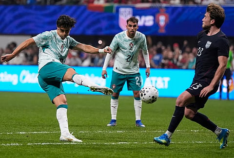 Portugal's Joao Felix kicks (10) a goal againmst USA goalkeeper Matt Freese during the second half of an international friendly soccer match, in Atlanta.