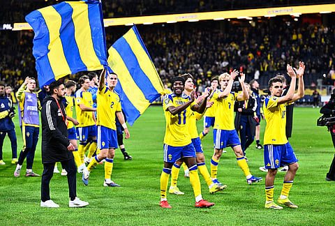 Sweden players and staff celebrate qualifying for the World Cup after a World Cup qualifying playoff final soccer match between Sweden and Poland in Stockholm.