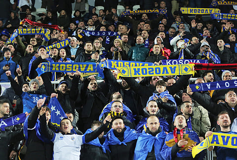Supporter for Kosovo celebrate ahead of the World Cup qualifying playoff final soccer match between Kosovo and Turkey in Pristina, Kosovo.