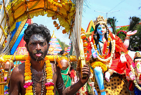 A man with his tongue pierced by a metal rod takes part in a procession during the 'Panguni Uthiram' festival, in Bhopal, Madhya Pradesh. The festival is celebrated to honour the Hindu God Murugan in the Tamil month of Panguni. 