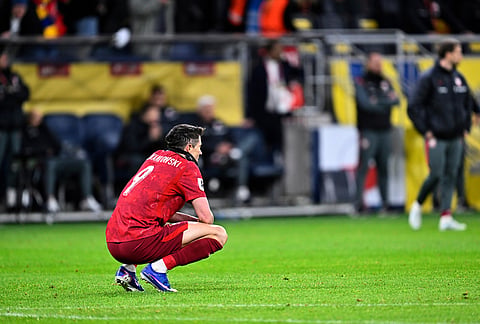 Poland's Robert Lewandowski reacts after losing in the World Cup qualifying playoff final soccer match between Sweden and Poland in Stockholm.