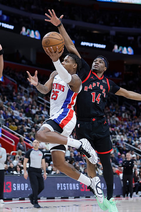 Detroit Pistons guard Marcus Sasser (25) goes to the basket past Toronto Raptors guard Ja'kobe Walter (14) during the second half of an NBA basketball game in Detroit. 