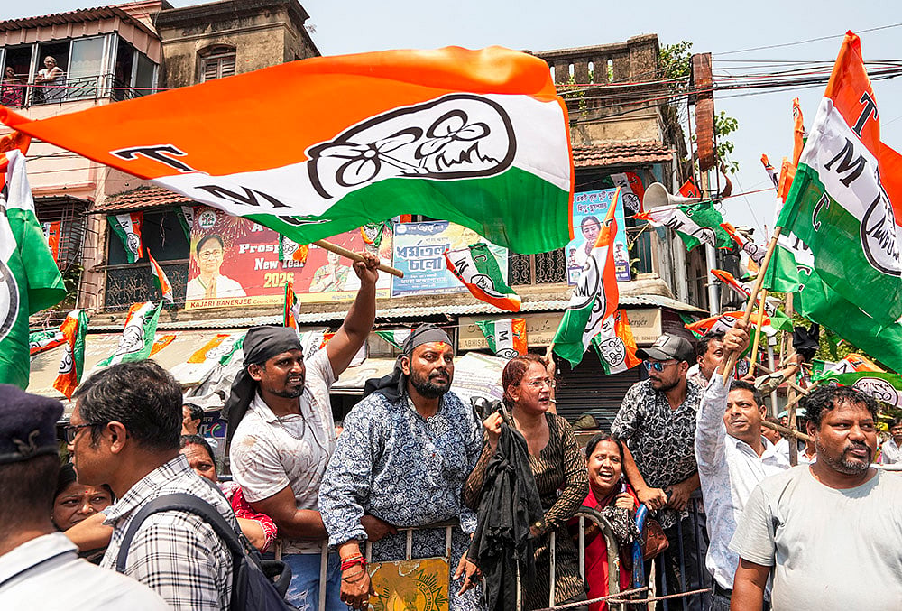 WB polls: TMC supporters shout slogans during a BJP roadshow 