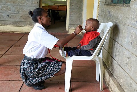 Mary Wanjiku, 20 feeds her son Stephan Keyllin during lunchtime at Greenland Girls School in Kiserian, Kajiado, Kenya.