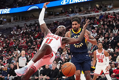 Chicago Bulls forward Leonard Miller (11) can't control a ball as Indiana Pacers forward Obi Toppin, right, looks on during the first half of an NBA basketball game in Chicago.