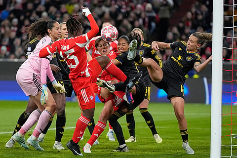 Bayern's Bernadette Kakounan challenges for the ball with Manchester United's Julia Zigiotti Olme, right, during the Women's Champions League quarterfinal second leg soccer match between Bayern Munich and Manchester United in Munich, Germany.