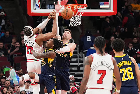 Indiana Pacers center Micah Potter, center, and guard Quenton Jackson, second from left, block a shot by Chicago Bulls forward Guerschon Yabusele, left, during the second half of an NBA basketball game in Chicago.