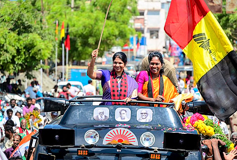 DMK Deputy General Secretary and MP Kanimozhi Karunanidhi, left, greets the gathering during an election campaign in support of party candidate for Manamadurai constituency, A. Tamilarasi Ravikumar, right, ahead of Tamil Nadu Assembly Election, in Sivaganga district. 