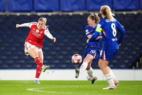 Arsenal's Alessia Russo, left, shoots the ball during the Women's Champions League quarterfinal second leg soccer match between Chelsea and Arsenal in London.