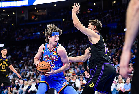 Oklahoma City Thunder center Branden Carlson (15) drives against Los Angeles Lakers forward Maxi Kleber (14) during the second half of an NBA basketball game in Oklahoma City. 