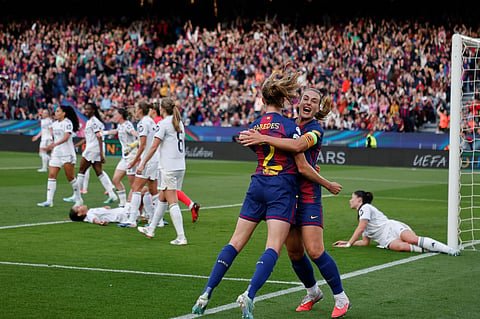 Barcelona's Irene Paredes celebrates after scoring her side's third goal during a Champions League quarterfinal soccer match between Barcelona and Real Madrid, in Barcelona, Spain.
