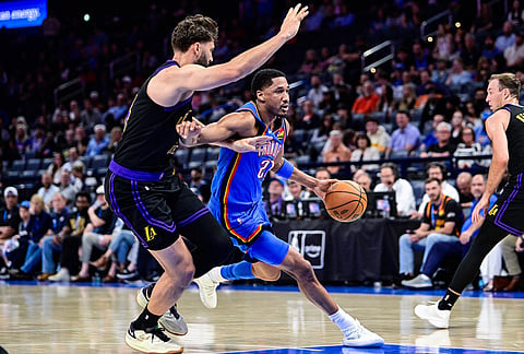 Oklahoma City Thunder guard Aaron Wiggins (21) drives against Los Angeles Lakers forward Maxi Kleber (14) during the second half of an NBA basketball game in Oklahoma City.