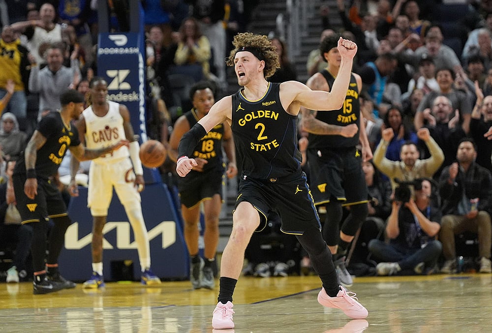 Golden State Warriors guard Brandin Podziemski (2) celebrates after teammate forward Gui Santos scored against the Cleveland Cavaliers during the second half of an NBA basketball game in San Francisco. - | Photo: AP/Jeff Chiu