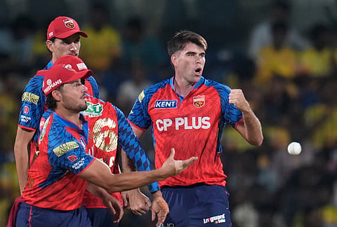 Punjab Kings' Xavier Bartlett celebrates the wicket of Chennai Super Kings' wicketkeeper Sanju Samson with teammates during the Indian Premier League cricket match between Chennai Super Kings and Punjab Kings in Chennai.