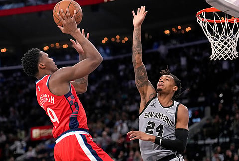 Los Angeles Clippers guard Bennedict Mathurin, left, shoots as San Antonio Spurs guard Devin Vassell defends during the second half of an NBA basketball game in Inglewood, California.