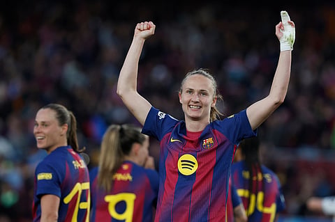 Barcelona's Graham Hansen celebrates after scoring her side's third goal during a Champions League quarterfinal soccer match between Barcelona and Real Madrid, in Barcelona, Spain.
