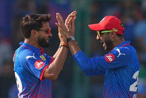 Delhi Capitals' Vipraj Nigam, left, celebrates the wicket of Mumbai Indians' Shefane Rutherford with Delhi Capitals' captain Axar Patel during the Indian Premier League cricket match between Delhi Capitals and Mumbai Indians in New Delhi.