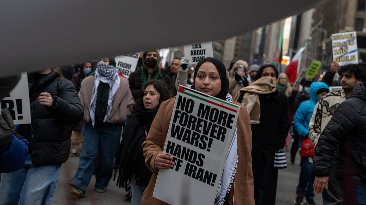 Source: IMAGO / ZUMA Press Wire | Representative Image  : March 13, 2026, New York, New York, USA: A woman carries a sign that reads, "No More Forever Wars! Hands Off Iran!" at an Al Quds Day rally in Times Square marching to Herald Square to mark the last day of Ramadan and to protest the US-Israel war on Iran.