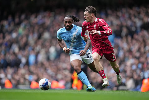 Manchester City's Antoine Semenyo, left, and Liverpool's Florian Wirtz run for the ball during the FA Cup quarter-final soccer match between Manchester City and Liverpool in Manchester, England.