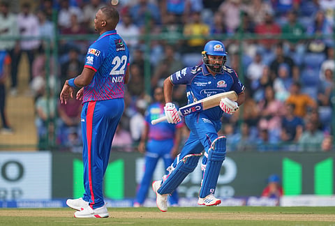 Mumbai Indians' Rohit Sharma runs between the wickets to score during the Indian Premier League cricket match between Delhi Capitals and Mumbai Indians in New Delhi.