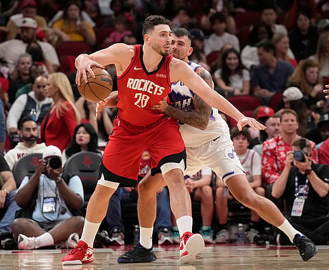 Houston Rockets center Alperen Sengun (28) controls the ball against Utah Jazz forward John Konchar, right, during the second half of an NBA basketball game, in Houston.