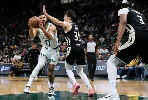 Boston Celtics' Jayson Tatum (0) drives to the basket against Milwaukee Bucks' Cormac Ryan during the second half of an NBA basketball game in Milwaukee.
