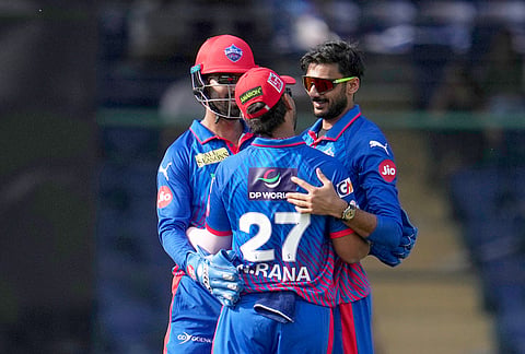 Delhi Capitals' captain Axar Patel, right, celebrates with teammates the wicket of Mumbai Indians' Rohit Sharma during the Indian Premier League cricket match between Delhi Capitals and Mumbai Indians in New Delhi.